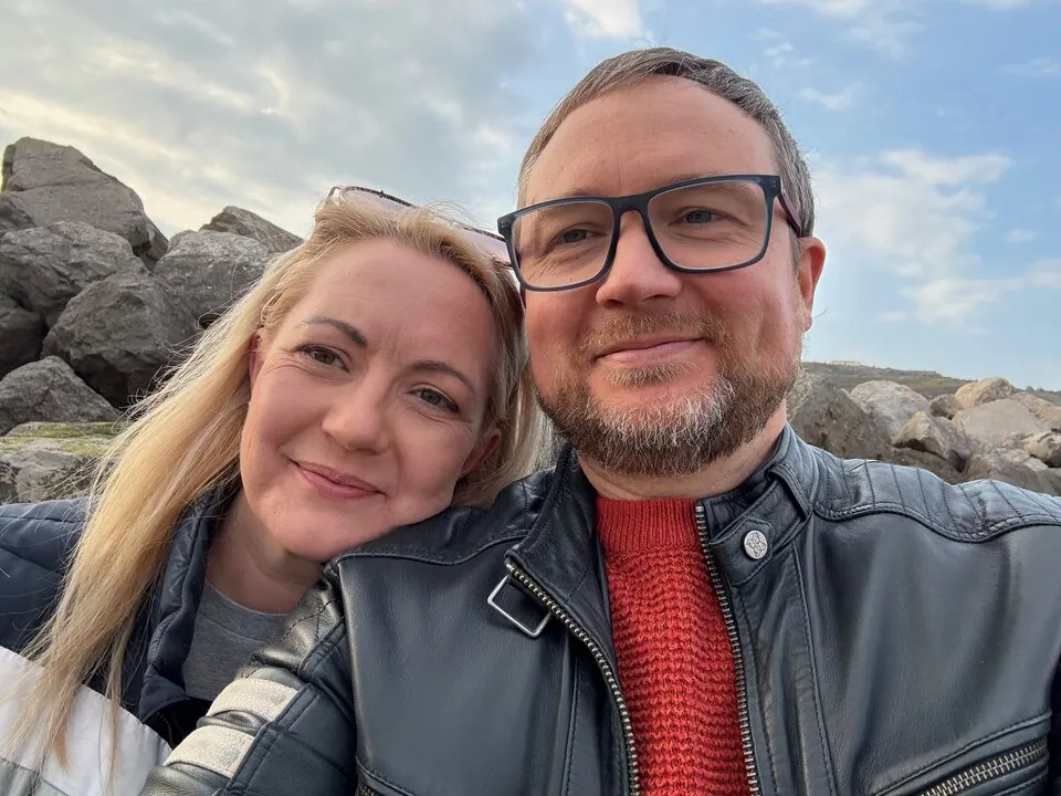 Lyne and Matthew smiling together outdoors